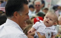 Mitt Romney holds up a baby wearing a "Dump Obama" pin at a campaign rally in Pueblo, Colorado September 24, 2012. REUTERS/Brian Snyder
