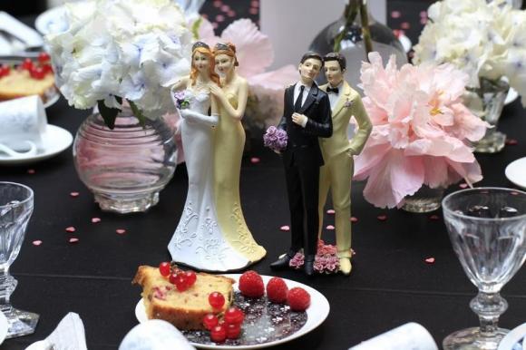 Same-sex couple plastic figurines are displayed during a gay wedding fair in Paris